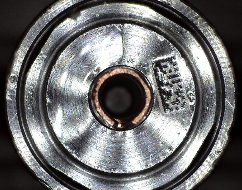 Fuel injector part with light oils on it before removal with CO2 spray cleaning